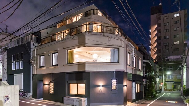 A modern two-story building with a balcony on the upper floor, large windows, and a well-lit entrance. - Satellite Hotel Komagome (Tokyo)