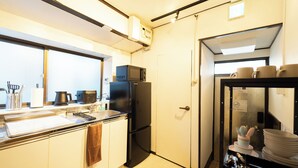 A compact kitchen with a refrigerator, microwave, and a sink. - Satellite Hotel Yoyogi Sangubashi (Tokyo)