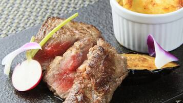 A steak with a garnish of radish and flower, served with a side of fries.