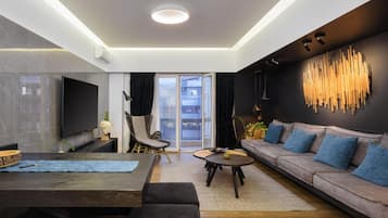 Exclusive Apartment, 4 Bedrooms | Living area | 70-inch flat-screen TV with cable channels, Smart TV, Netflix