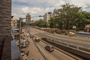 A multi-lane urban road with vehicles, a blue bus, and a yellow taxi.