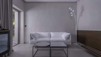 Un salon moderne avec un canapé blanc, une table basse ronde et un grand lampadaire.