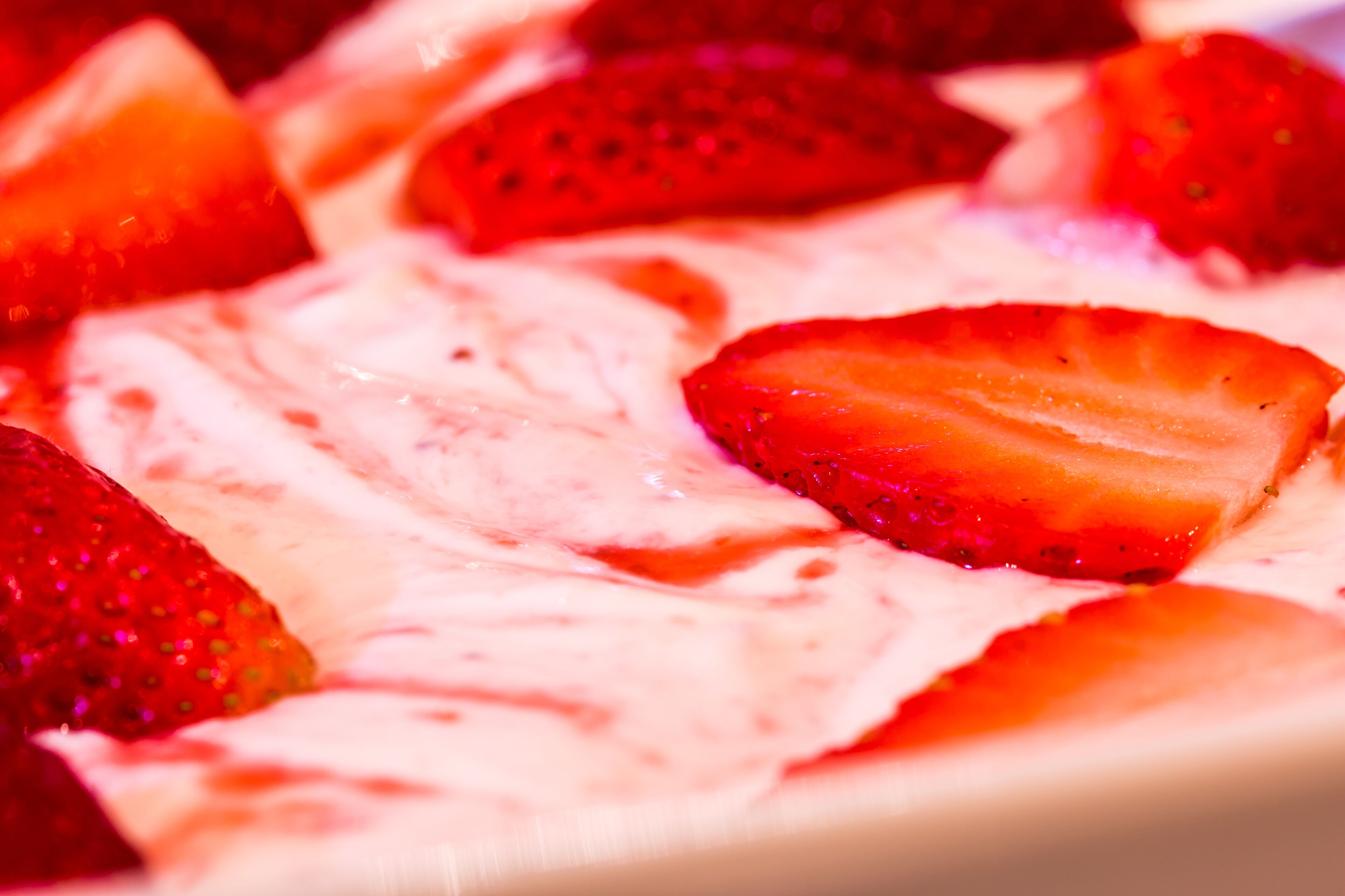 A dessert with strawberries and a creamy topping.