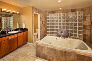 A bathroom with a freestanding bathtub, a vanity with a sink, and a large mirror.