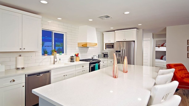 A modern kitchen with white cabinetry, a large island, and stainless steel appliances. - Old Town Retreat (Scottsdale)