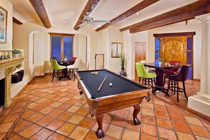 A billiards room with a pool table, chairs, and a fireplace. - Hacienda Estate (Scottsdale)