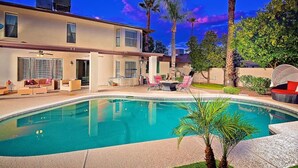 A modern two-story house with a swimming pool, outdoor seating, and palm trees. - Kierland Getaway (Scottsdale)