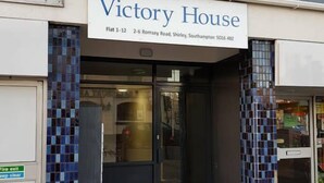 The exterior of Victory House, a flat at 1-12, 2-6 Romney Road, Shirley, Southampton SO16 4HZ. It features a tiled entrance with a fire exit sign and a clear path leading to the door.