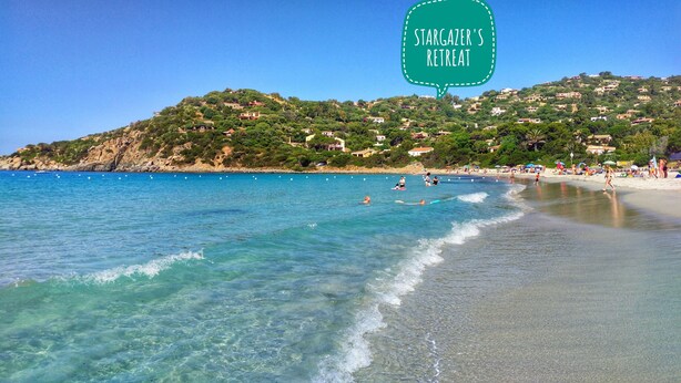 A beach with clear turquoise water, a sandy shore, and a hillside with buildings in the background. - Luxury Beach Escape, Sea View Hottub,cinema Lounge (Maracalagonis)