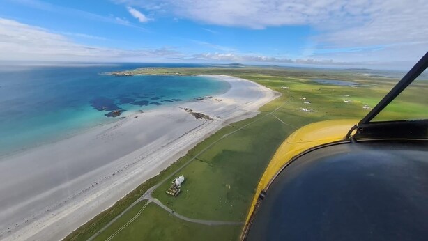 An aerial view of a coastal area with a beach, clear blue waters, and green fields. - Kirkapol Beach Sleeps 4 With Dog Access (Tiree Island)