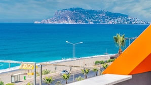 A coastal view with a beach, a sign reading "LETSKI", and a mountain in the background. - Arsi Paradise Beach Hotel (Alanya)