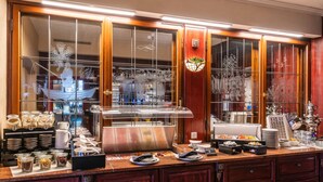 A buffet setup with various food items and utensils.