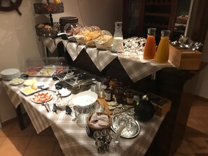 A buffet setup with various food items and beverages.