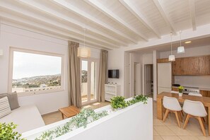 A modern apartment with a balcony, a dining area, and a kitchen.