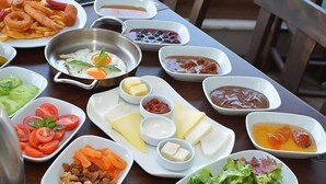 A table with various dishes including seafood, salads, and condiments. - Cesmeli Boutique Hotel (Cesme)