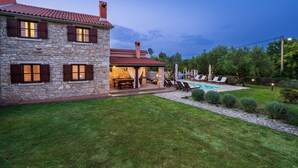 A stone house with a red-tiled roof, a swimming pool, and a patio area with outdoor furniture. - House 1993/28059 (Istria - Rakalj), 900m from the beach (Rakalj)