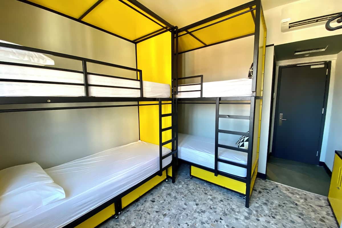 A bunk bed room with a tiled floor and a door to the right.