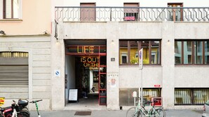 A building with a neon sign reading "Life is out of the box" and a bicycle parked outside. - YellowSquare Milan (Milan)