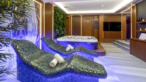 A spa area with a hot tub, lounge chairs, and a waterfall feature. - Vital Hotel Fulya (Istanbul)