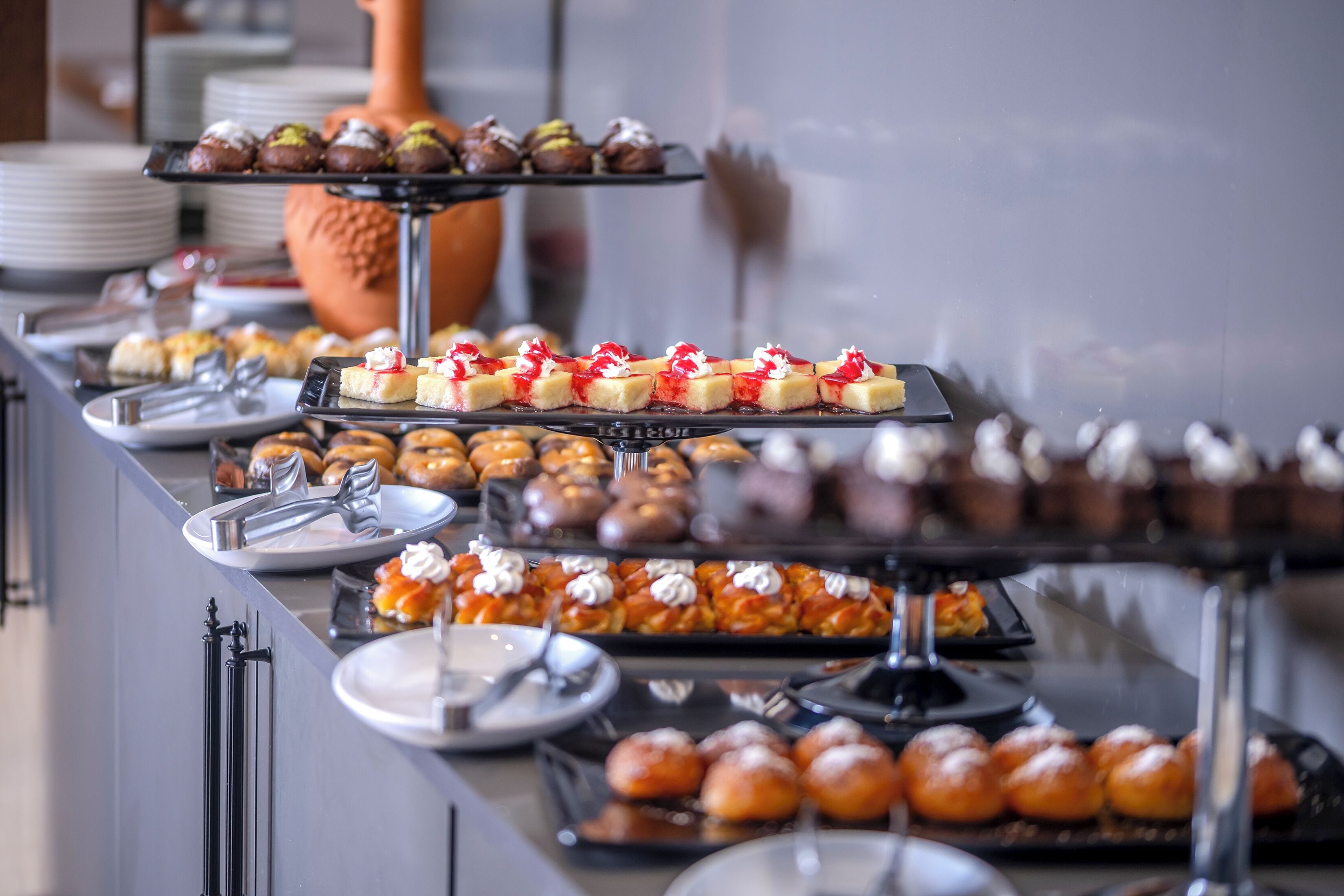 A buffet with various desserts and pastries.