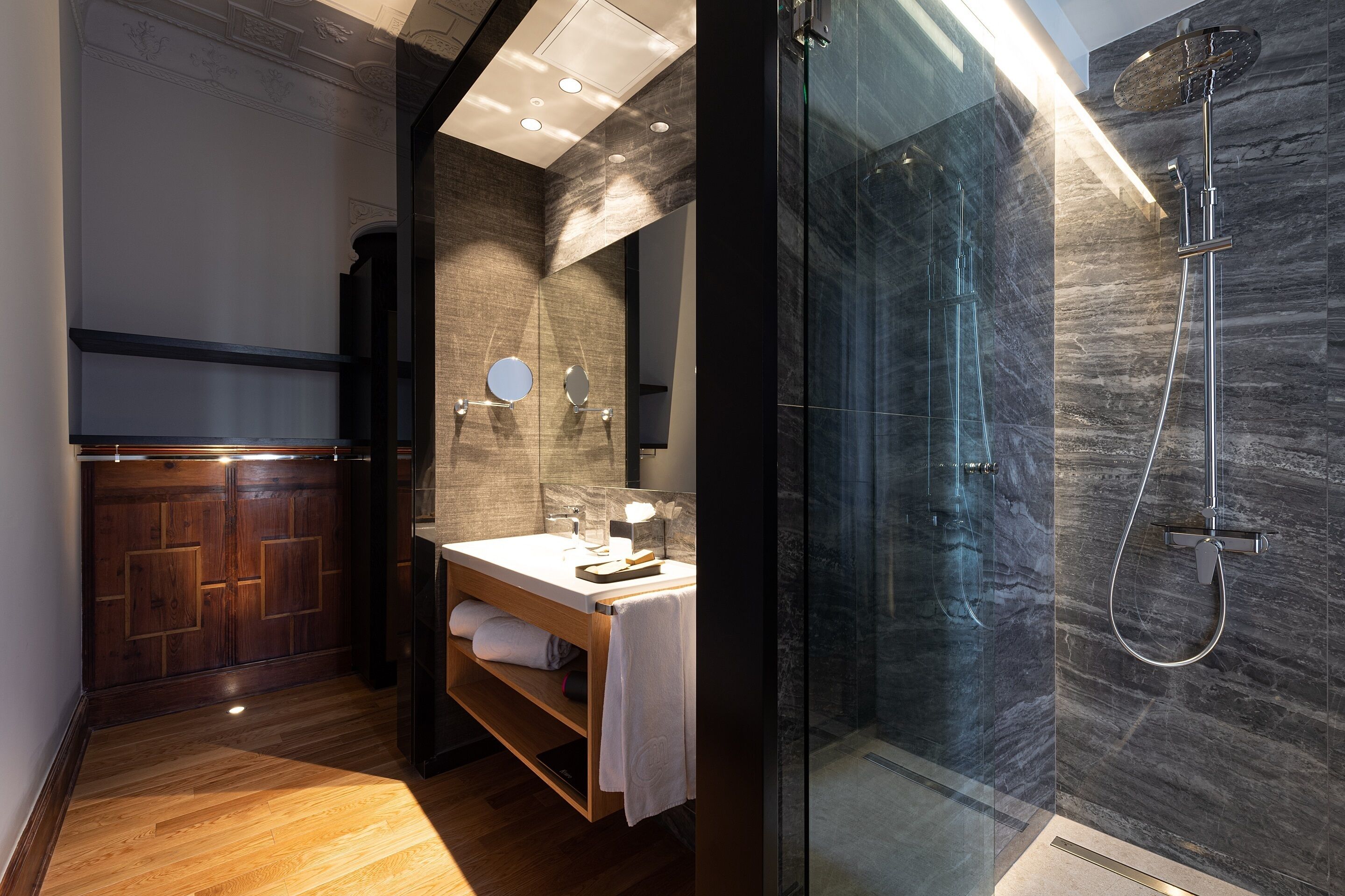 deluxe room | bathroom | shower, rainfall showerhead, hair dryer, towels