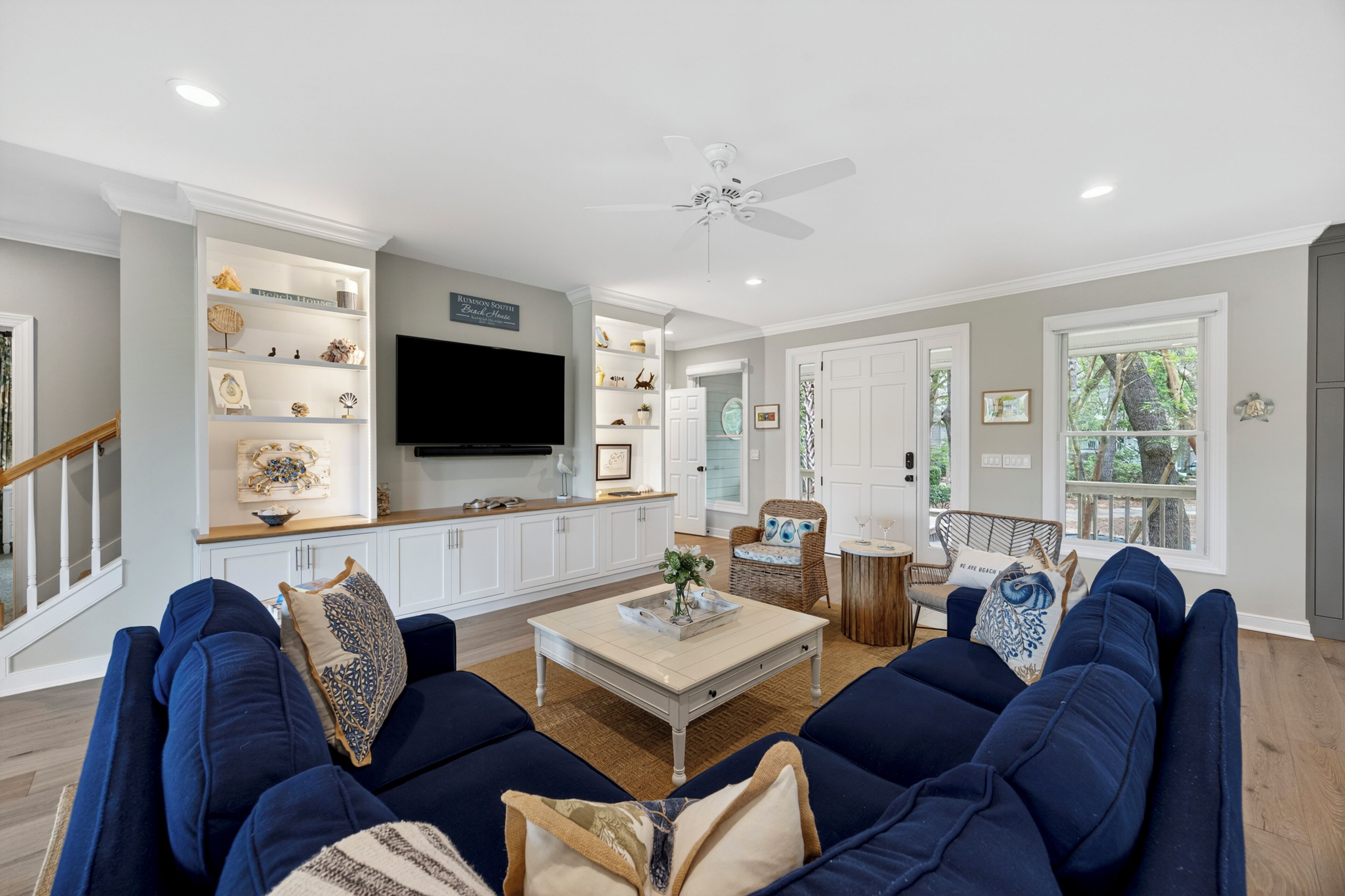A living room with a sofa, coffee table, and a flat-screen TV.