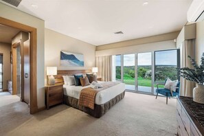 A bedroom with a large bed, a nightstand, a window with a view, and a chair. - Incognito—An Exclusive Oceanfront Estate (Gracetown)