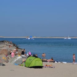 Guests can enjoy the beach with its calm sea and scenic views.