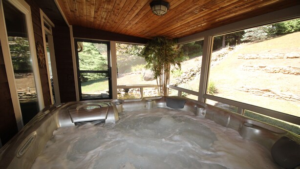 A hot tub with a wooden ceiling and large windows overlooking a natural landscape. - Luxury Mountain Cabin w/ Hot Tub 75 Private Acres, & Near New River (Jefferson)