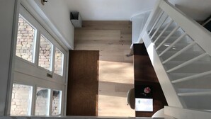 A staircase with white railings leading to a landing.