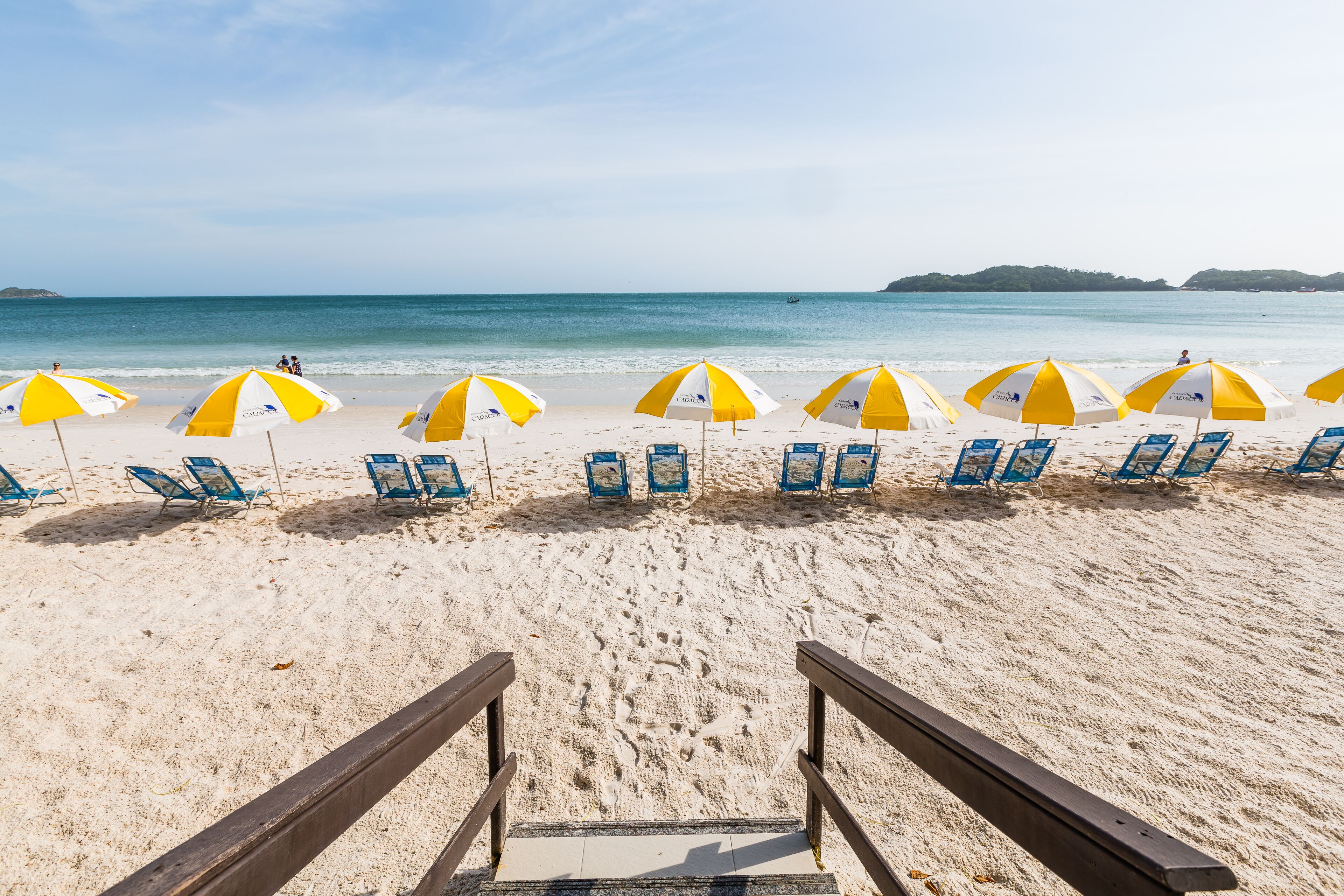 On the beach, white sand, sun-loungers, beach towels