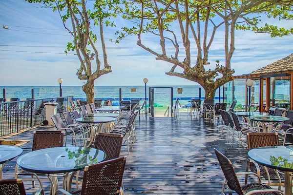 On the beach, white sand, sun loungers, beach towels