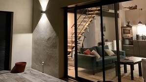 A modern interior with a staircase, a sofa, and a dining area. - LOFT VILLAGE HOUSE+AIR CONDITIONING+TERRACE, NEAR THE GOLF COURSE. (Vernègues)