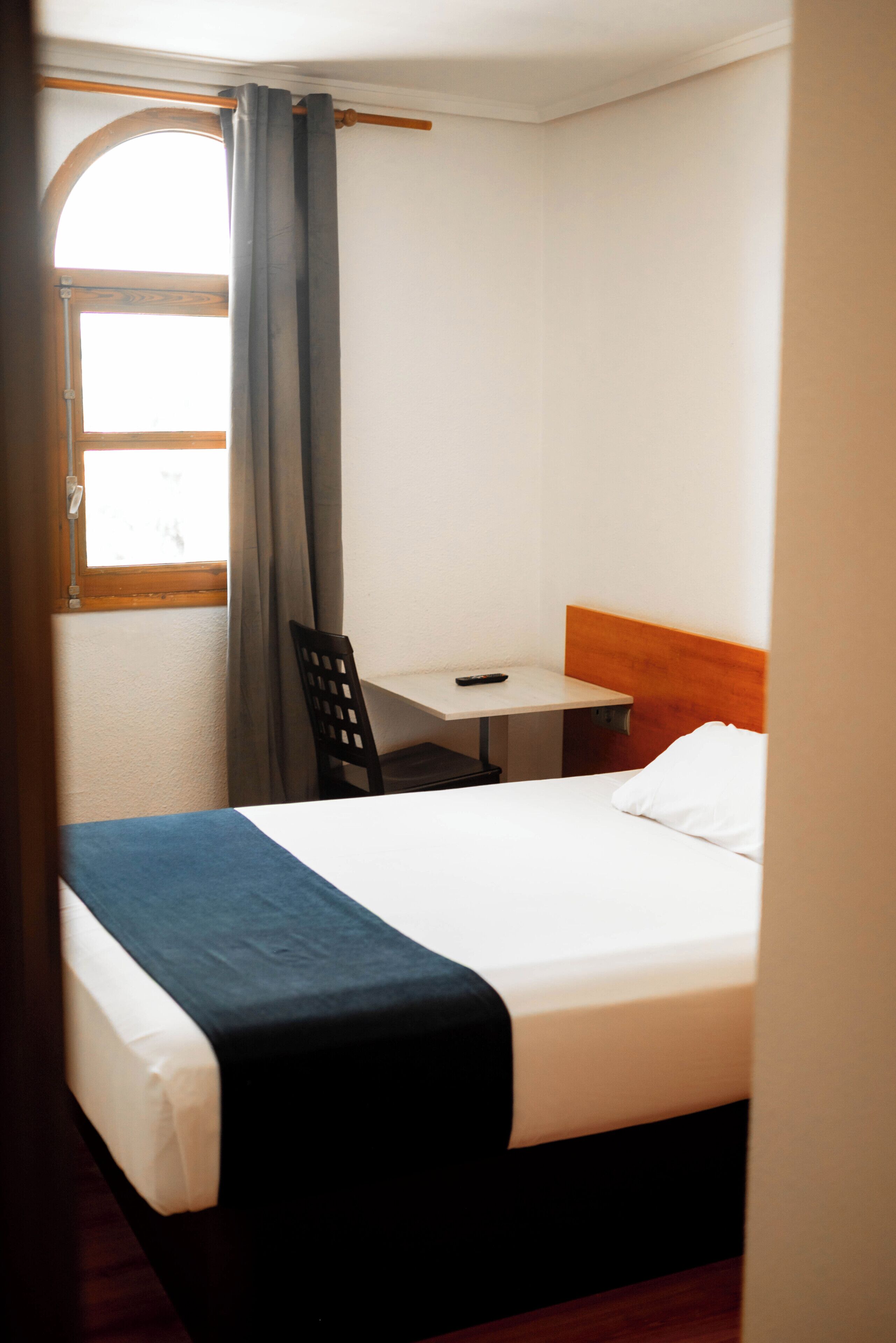 Premium bedding, laptop workspace, blackout drapes, soundproofing