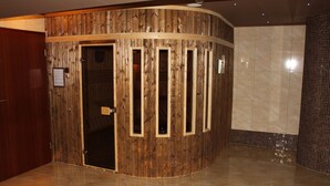 A corner room with a wooden wall, a tiled floor, and a tiled shower area. - Hotel Gniecki (Pruszcz Gdanski)