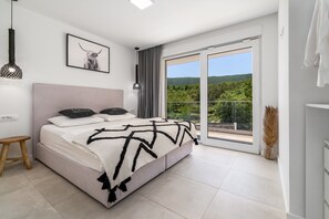 A modern bedroom with a large bed, a view of greenery through the sliding glass door, and a pendant light above the bed. - Villa Zen with private 32 sqm pool, summer kitchen, 7 km from the beach (Tugare)