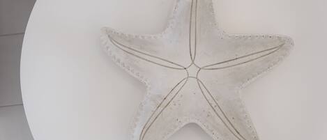 A white starfish decoration on a white surface.