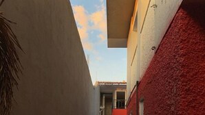A narrow alleyway with a staircase leading to a building.