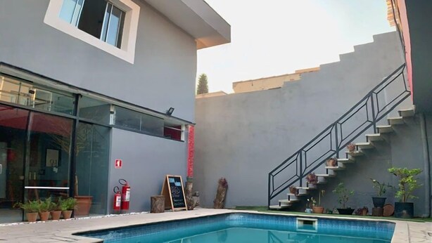 A modern building with a swimming pool, a staircase, and a fire extinguisher.