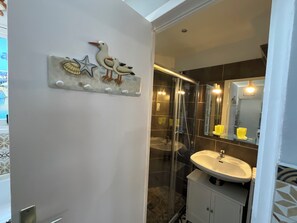 Shower, hair dryer, towels, toilet paper