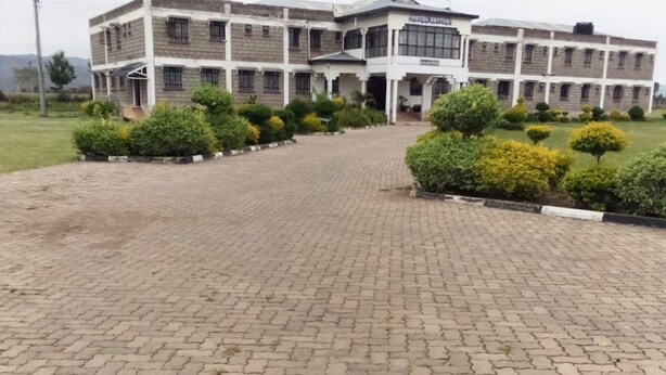 A hotel with a paved courtyard, multiple buildings, and well-maintained greenery. - Dayton Hotel (Nakuru)