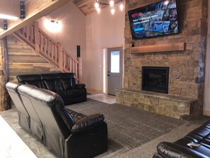 Spacious living room with cozy gas fireplace and a smart TV to stream your favorite shows/movies