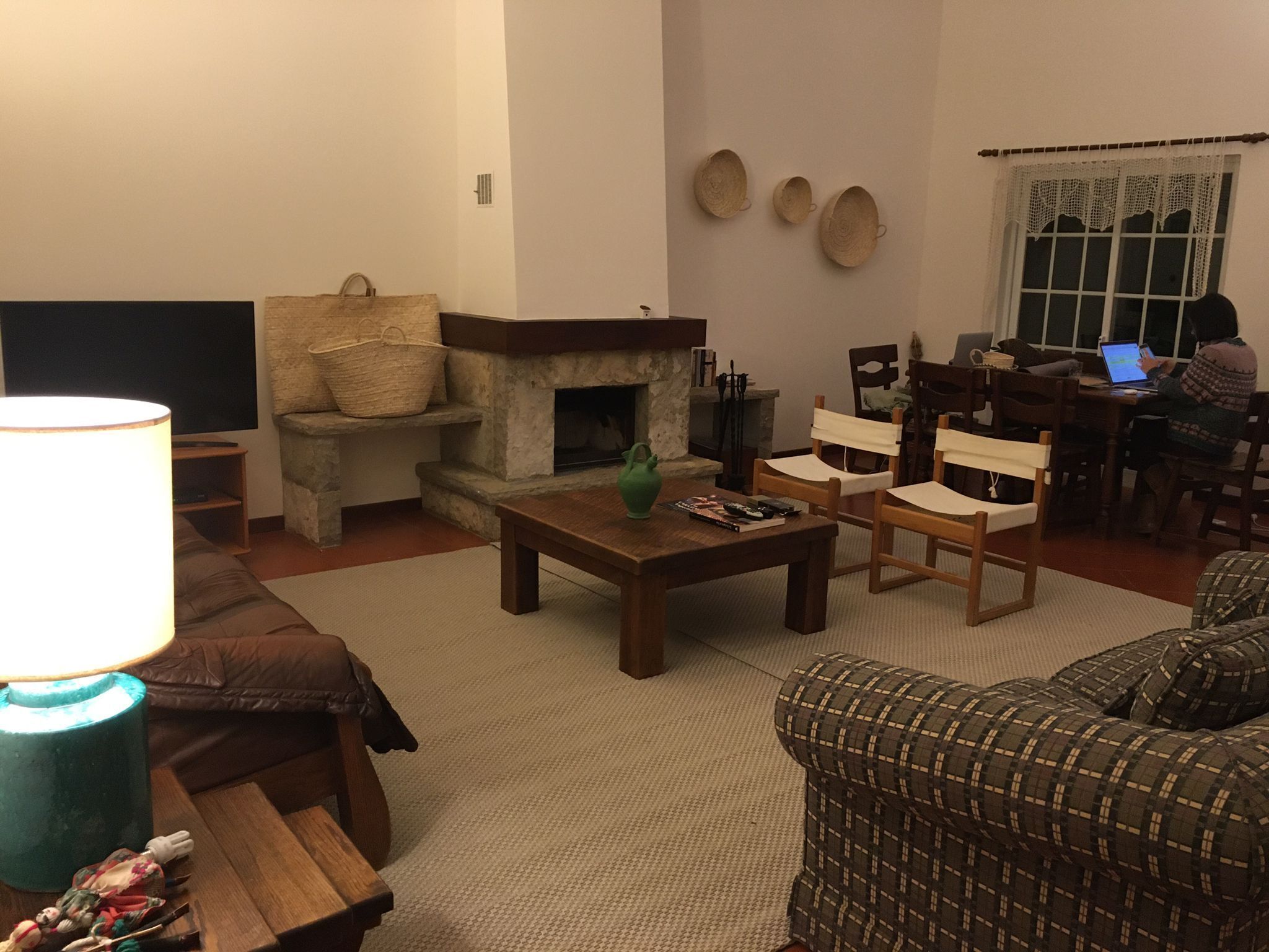A cozy living room with a fireplace, comfortable seating, and a television.