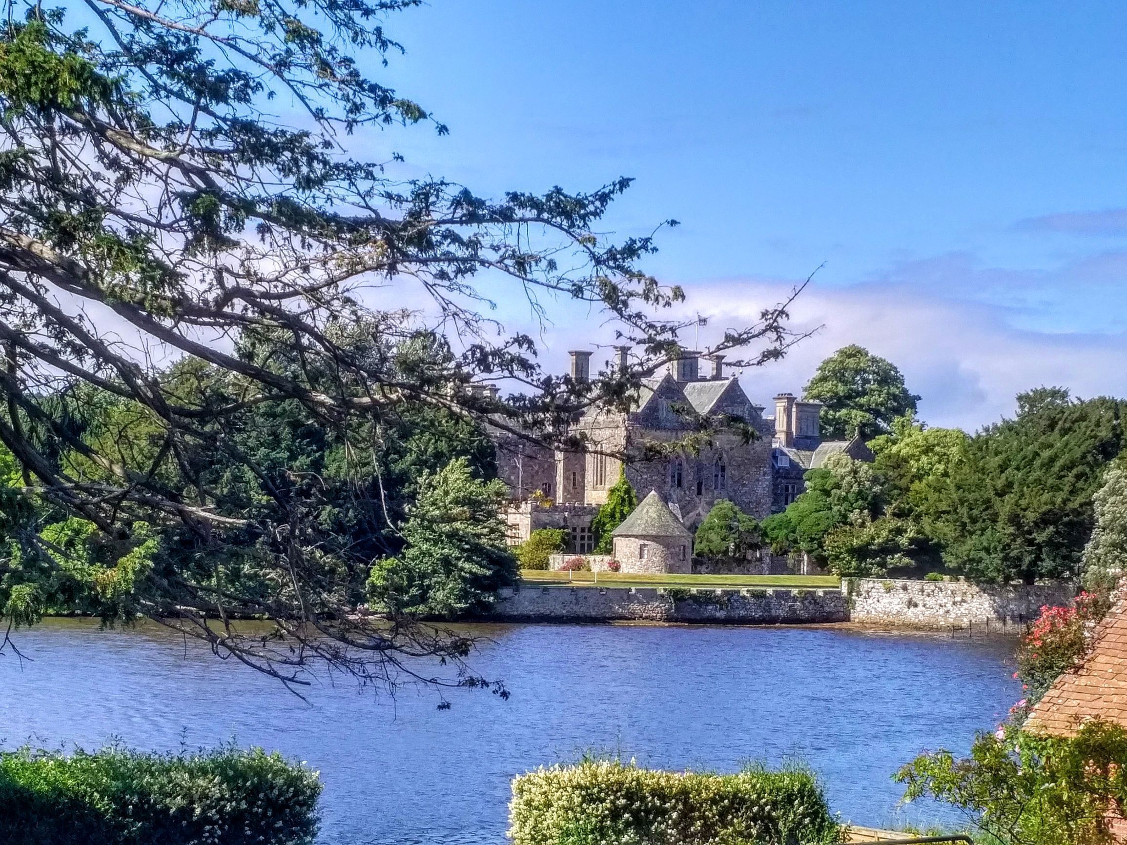A historic stone building with multiple towers and a moat.