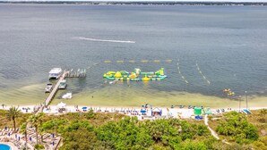 A beach with a pier, a water park, and a pool. - Summer is here @ Portofino 2-1409! (Pensacola Beach)