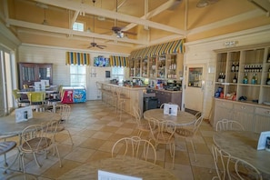 Enjoy a classic dining experience with round tables, a bar, and comfortable seating.