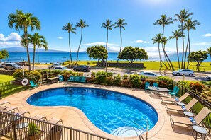 A swimming pool with lounge chairs and a view of the ocean. - Stunning Upstairs Unit with Direct Ocean View, Steps to  Beach.  Heart of Kihei (Kihei)