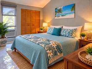 A bedroom with a bed, nightstands, a window, a closet, and a beach-themed painting on the wall. - Stunning Upstairs Unit with Direct Ocean View, Steps to  Beach.  Heart of Kihei (Kihei)