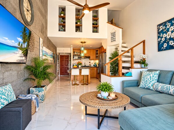 A spacious living area with a kitchen, a dining area, and a staircase leading to an upper level. - Stunning Upstairs Unit with Direct Ocean View, Steps to  Beach.  Heart of Kihei (Kihei)
