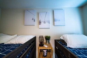 A hotel room with two beds, a small wooden table with a plant, and three framed pictures on the wall. - The Snowberry Sanctuary Lakefront Georgetown (Georgetown)